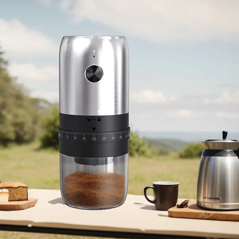 Coffee grinder with coffee beans on a table outdoors